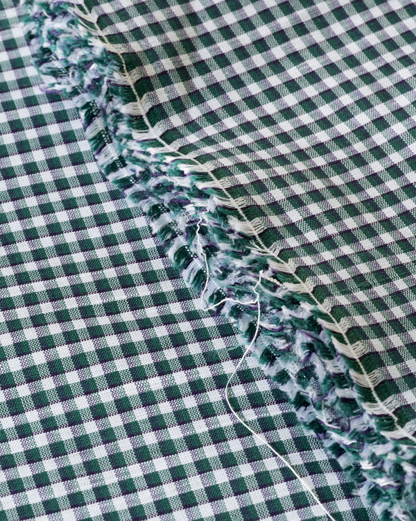 Close up image of green gingham deadstock linen cotton fabric for sewing home made clothes 